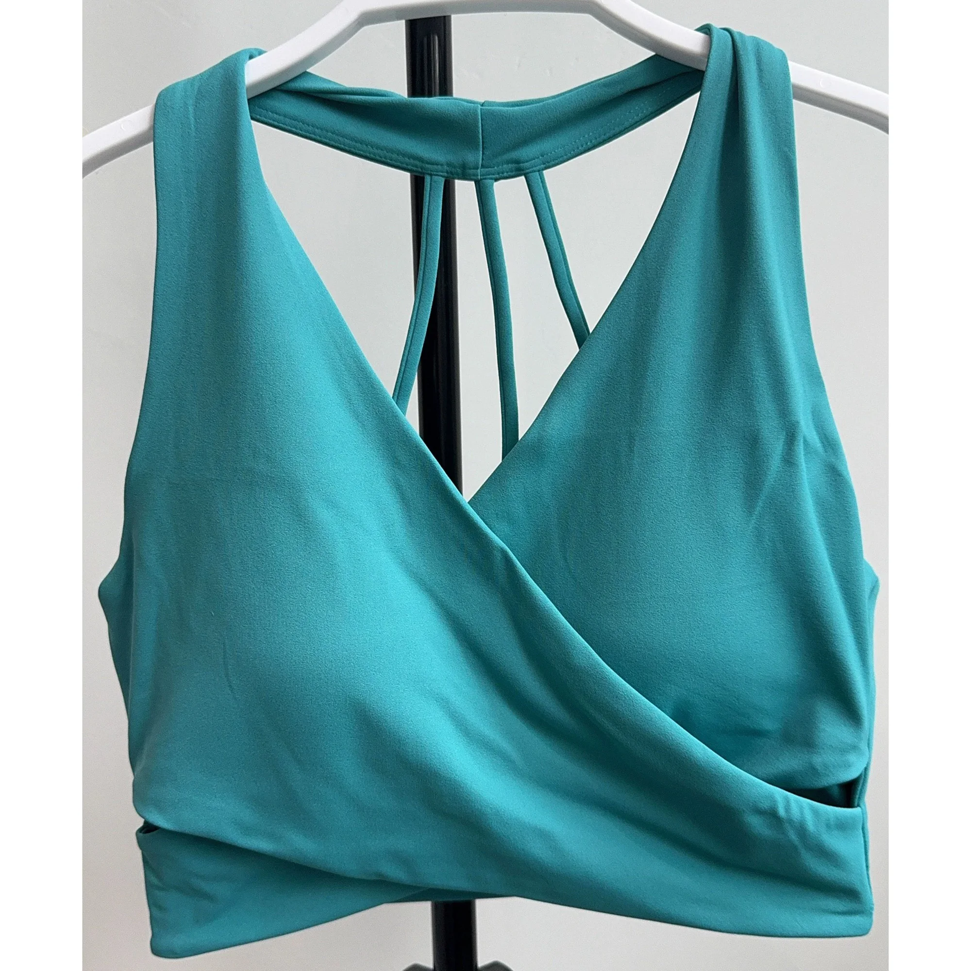 Front view of turquoise wrap-front sports bra