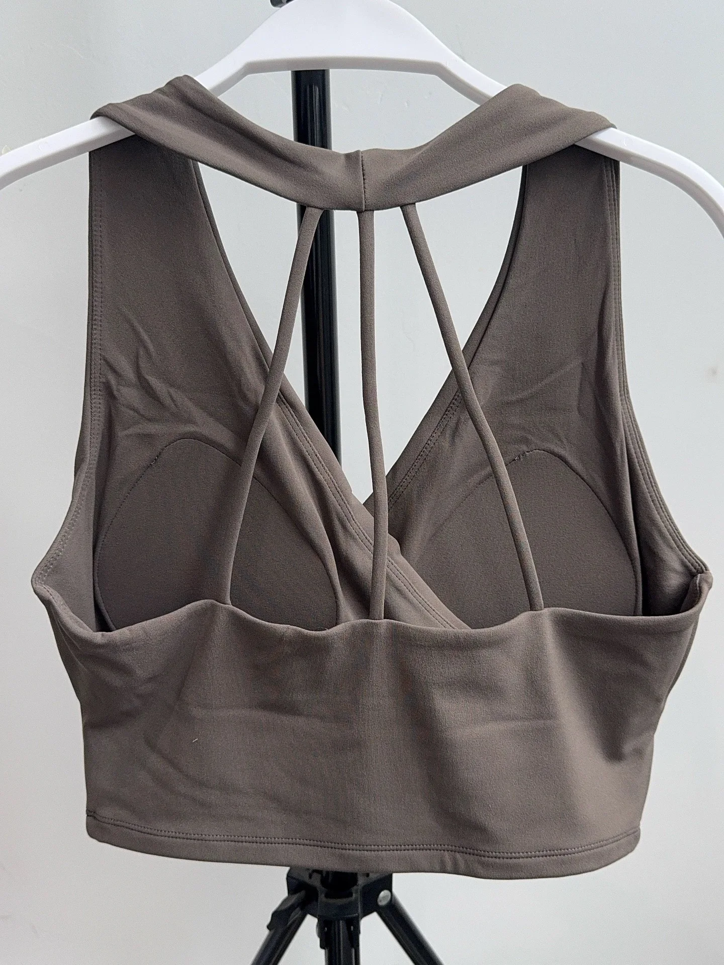 Back view of dark gray sports bra with slim straps and padded cups