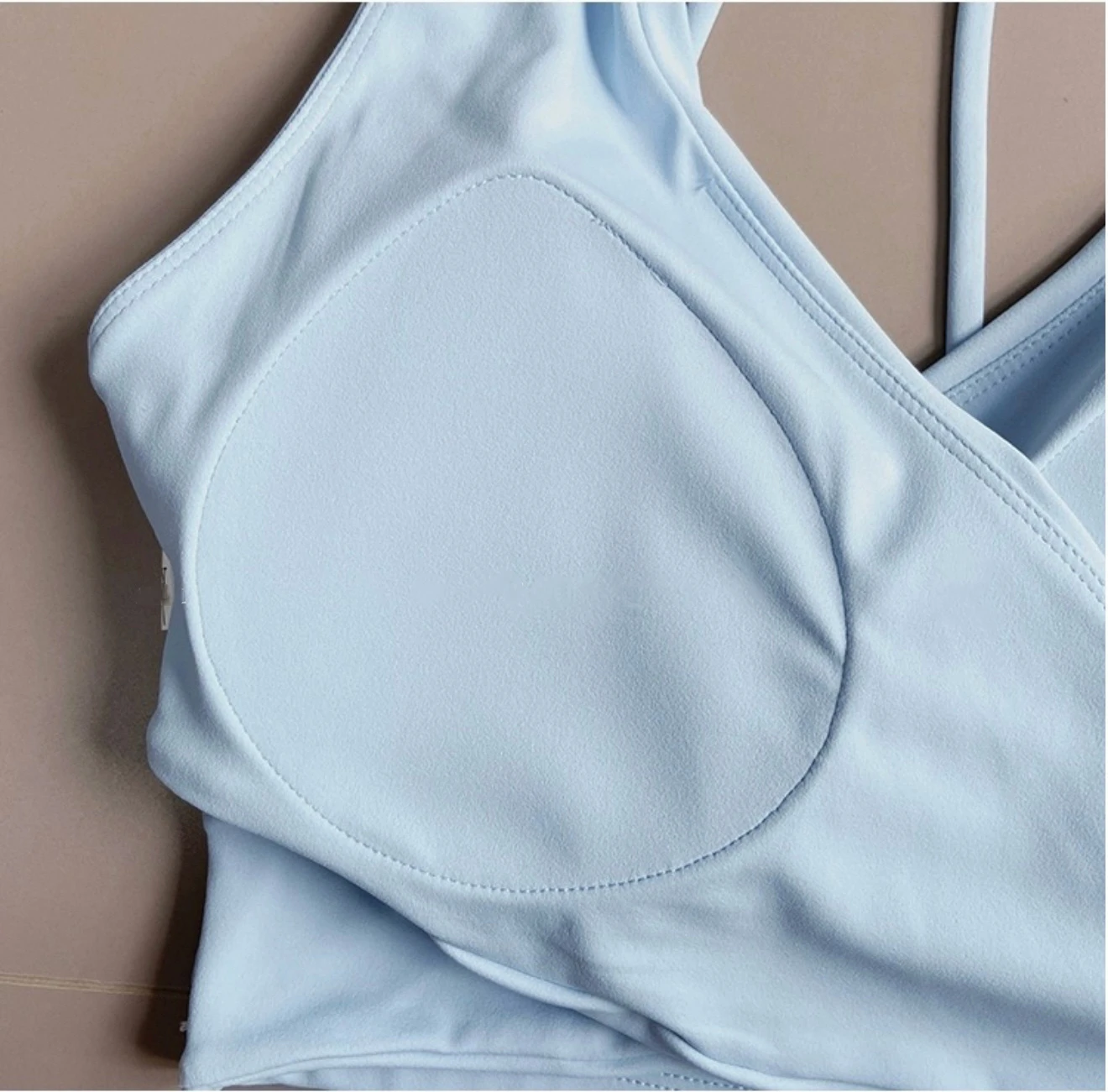 Close view of padded cup in sky blue sports bra