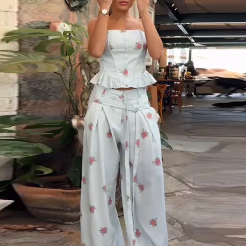 Woman wearing an ivory floral sleeveless top and wide-leg pants set