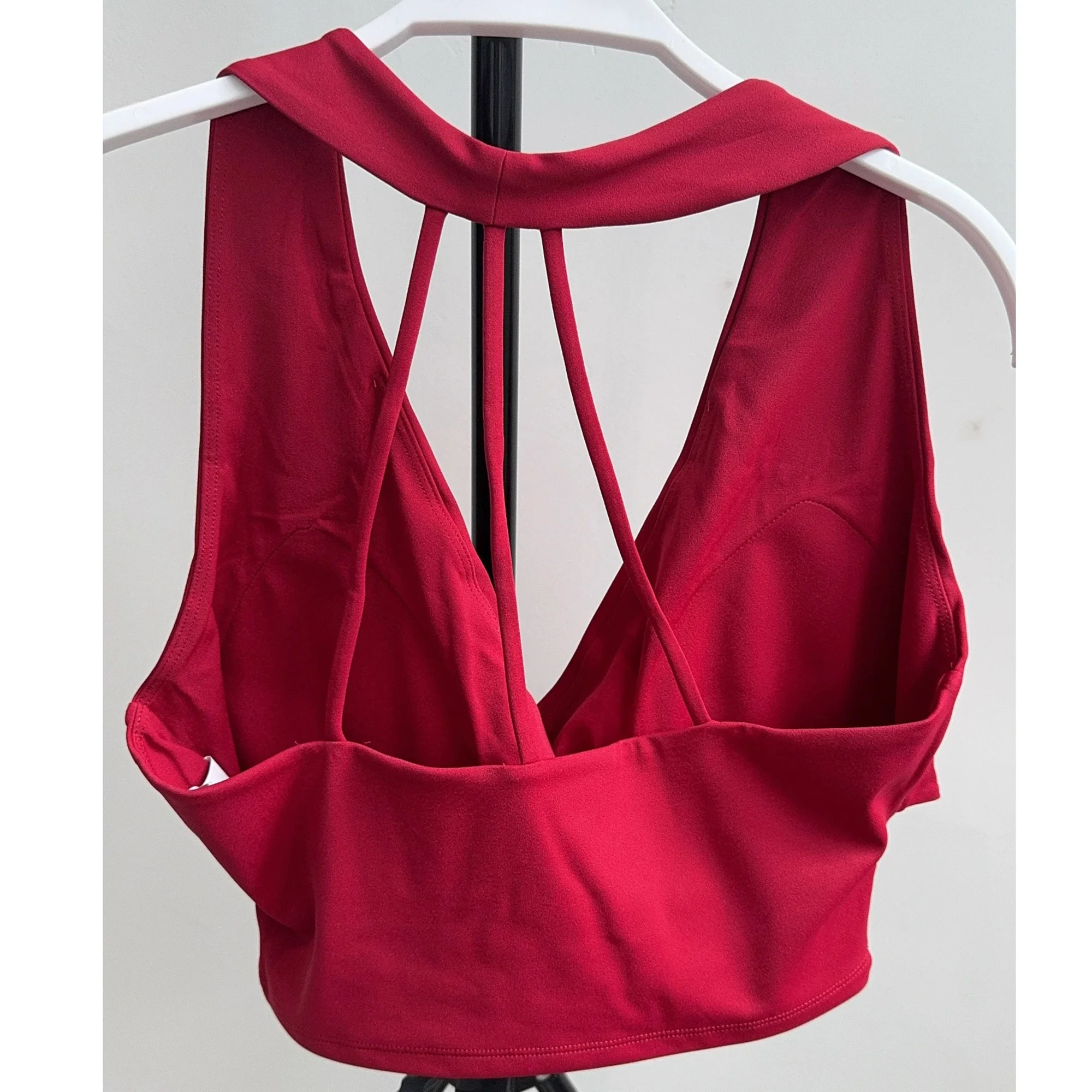 Back view of red sports bra with slim straps and padded cups