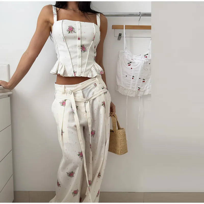 Close front view of ivory floral top and belted pants