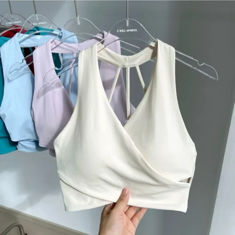White wrap-front sports bra displayed with multiple color options